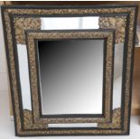 A 19th Century Dutch, gilt metal mounted ebonised wall mirror with marginal plate, ripple moulded