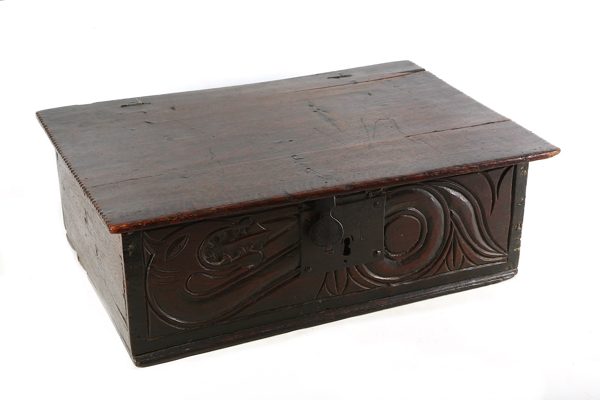 A 17th Century oak bible box, the front panel carved with a coiled dragon.