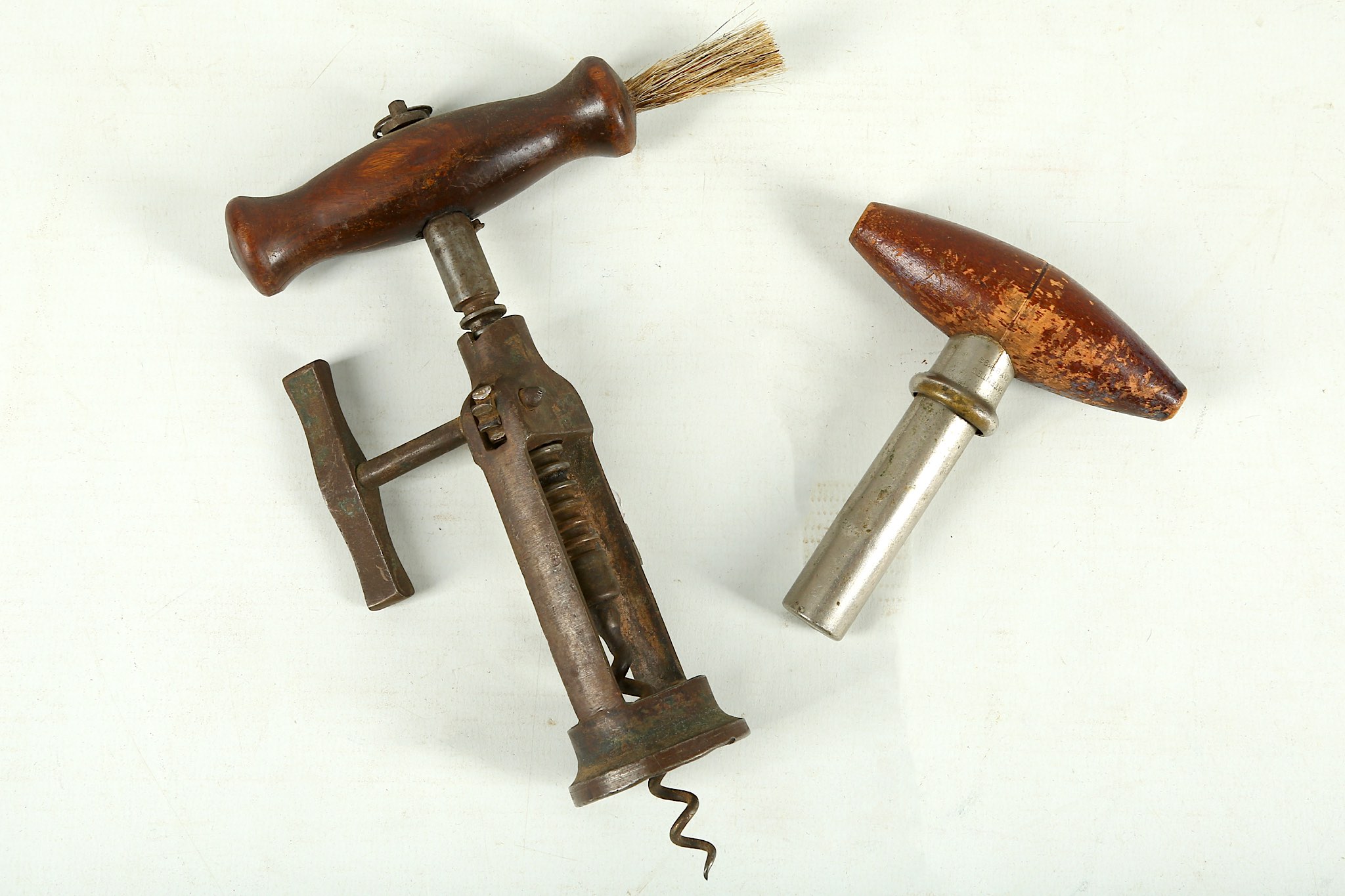 A 'London Rack' corkscrew, with a turned wood handle, brush and lanyard ring, iron body, 18.5cm