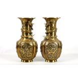 A pair of 20th Century bronzed baluster shaped Chinese vases, the neck surrounded by imperial dragon