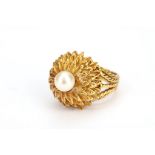 A cultured pearl dress ring, to a raised textured mount, ring size M
