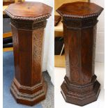 A pair of Edwardian octagonal mahogany pedestals, the stepped tops and bases with carved detail. The