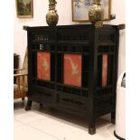 A 20th Century Chinese gilt metal moulded ebonised cabinet, inset four embroidered dragon panels,