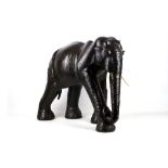 A mid 20th Century realistic study, in leather, of an elephant standing, 72cm high x 83cm long, body