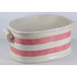 Victorian pottery two handled footbath with pink glazed bands, L 57 cm