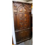 A George III mahogany two part barrel back standing corner cabinet, enclosed by 4 panelled doors
