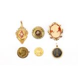 A group of jewellery, including three brooches, two pendants and a loose coin, one brooch with UK