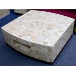 A contemporary coffee table manufactured by Nature Squared, made from random sections of coco wood