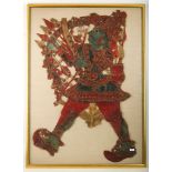 A large 19th Century Indonesian shadow theatre puppet in painted hide, mounted, glazed and framed,