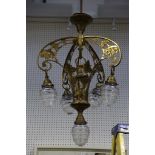 An Art Nouveau brass 5 branch ceiling light the cast floral frame with clear facetted shades.