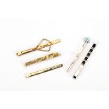 Five tie clips, including three 9ct gold examples and a cultured pearl-set one, three with UK