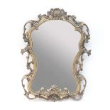A shaped gilt wall mirror with scroll and shell surmount,