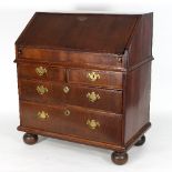 An early 18th Century fruitwood and feather crossbanded bureau,