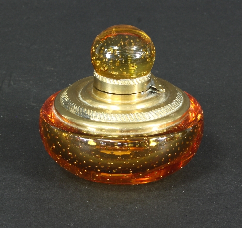 A Whitefriars controlled bubble amber glass inkwell, of squat circular form with brass mounts,