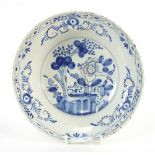 An 18th Century blue and white delft pottery dish decorated with a central scene of a tree and