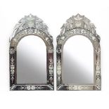 A pair of Venetian engraved mirror framed mirrors with scroll cresting,