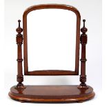 A Victorian mahogany dressing mirror with arched topped mirror and turned supports on an arched