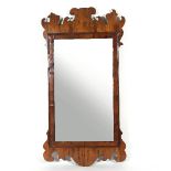 A George III walnut fret carved mirror, the plate with moulded surround,