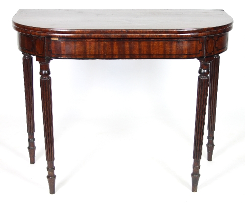 A Regency mahogany D-shaped tea table on reeded tapering legs,