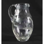 A glass jug etched with a giraffe amongst trees,
