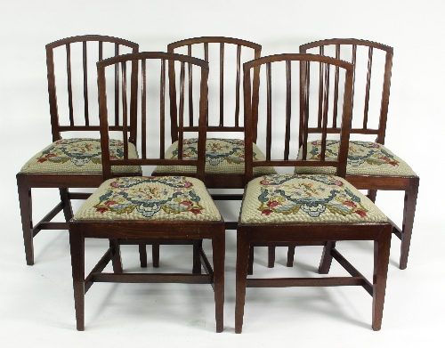 A set of five mahogany dining chairs with moulded splat backs and needlework seats