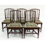 A set of five mahogany dining chairs with moulded splat backs and needlework seats