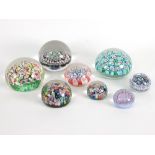 A group of eight glass paperweights,