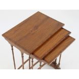 A nest of three satinwood banded tables on turned legs with back stretcher,