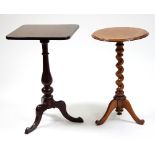 A circular walnut occasional table with twisted column on tripod support,
