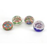 A group of four playing card style glass paperweights, the canes decorated with the various suits,