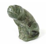 A carved soapstone figure of a seated dog,