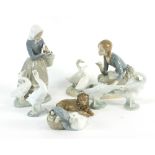 A Lladro porcelain figure of a girl with a basket of vegetables feeding two geese,