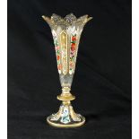 A Bohemian glass vase with ogee shaped rim and white overlay panels decorated in flowers and gilt,