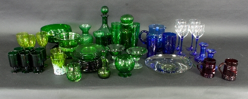 A large quantity of blue and green coloured glass, to include decanters, jugs, drinking glasses,