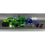 A large quantity of blue and green coloured glass, to include decanters, jugs, drinking glasses,