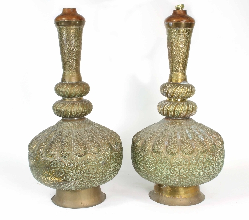 A pair of Middle Eastern brass vases lobed embossed decoration throughout, adapted as lamps,