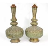 A pair of Middle Eastern brass vases lobed embossed decoration throughout, adapted as lamps,