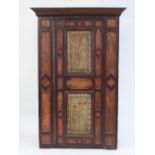 An Austrian Tyrolean painted wardrobe with moulded cornice,