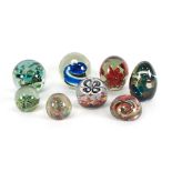 A group of eight Murano and Mdina glass paperweights, variously decorated,