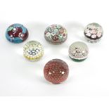 A group of six Murano glass paperweights, variously decorated with millefiori canes,