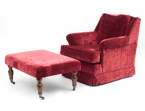 An easy chair upholstered in red corduroy and a matching ottoman