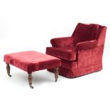 An easy chair upholstered in red corduroy and a matching ottoman