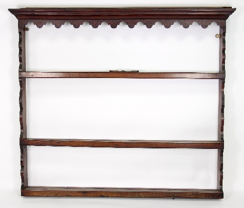 A George III oak and fruitwood delft plate rack of three shelves with shaped frieze,