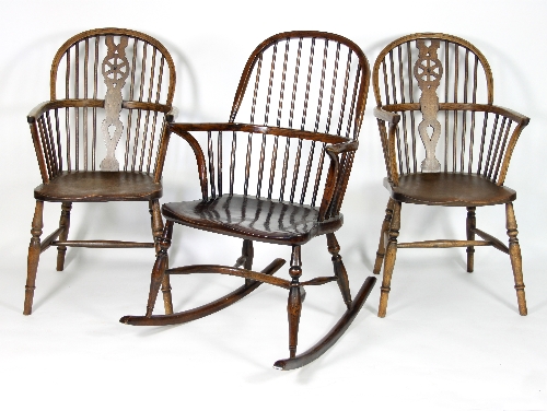 A pair of stick and pierced splat back armchairs with solid seats on turned legs and a stick back