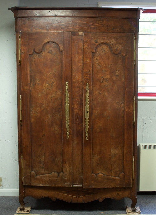 A French provincial elm and chestnut armoire,