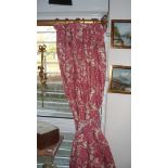 A pair of red and cream curtains printed with putti, urns and floral sprays,