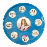 A Sèvres style circular tray with central portrait of Louis XIV and surround of eight portraits of