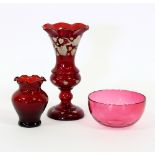 A ruby tinted vase with serrated border,