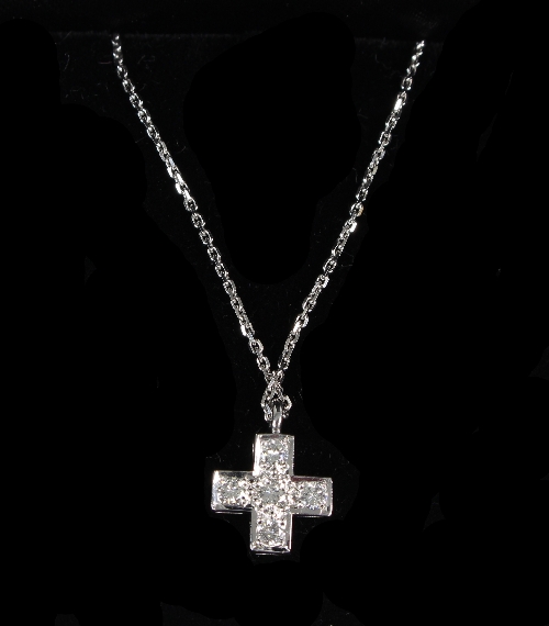 A diamond cross-shaped pendant set in 18ct white gold to a fine link neck chain