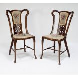 A pair of Edwardian side chairs with needlework backs and seats